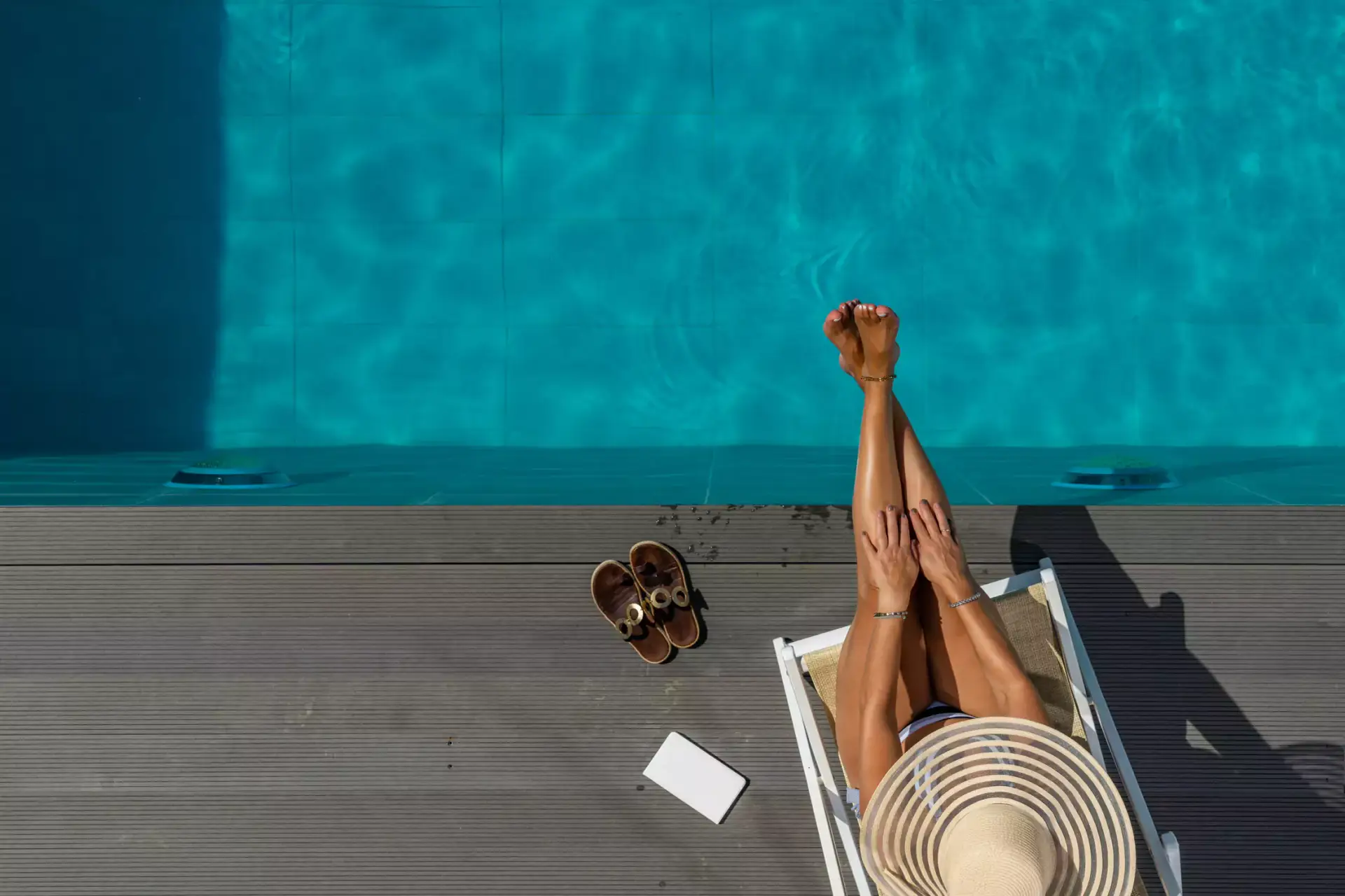 Woman relaxing by container pool